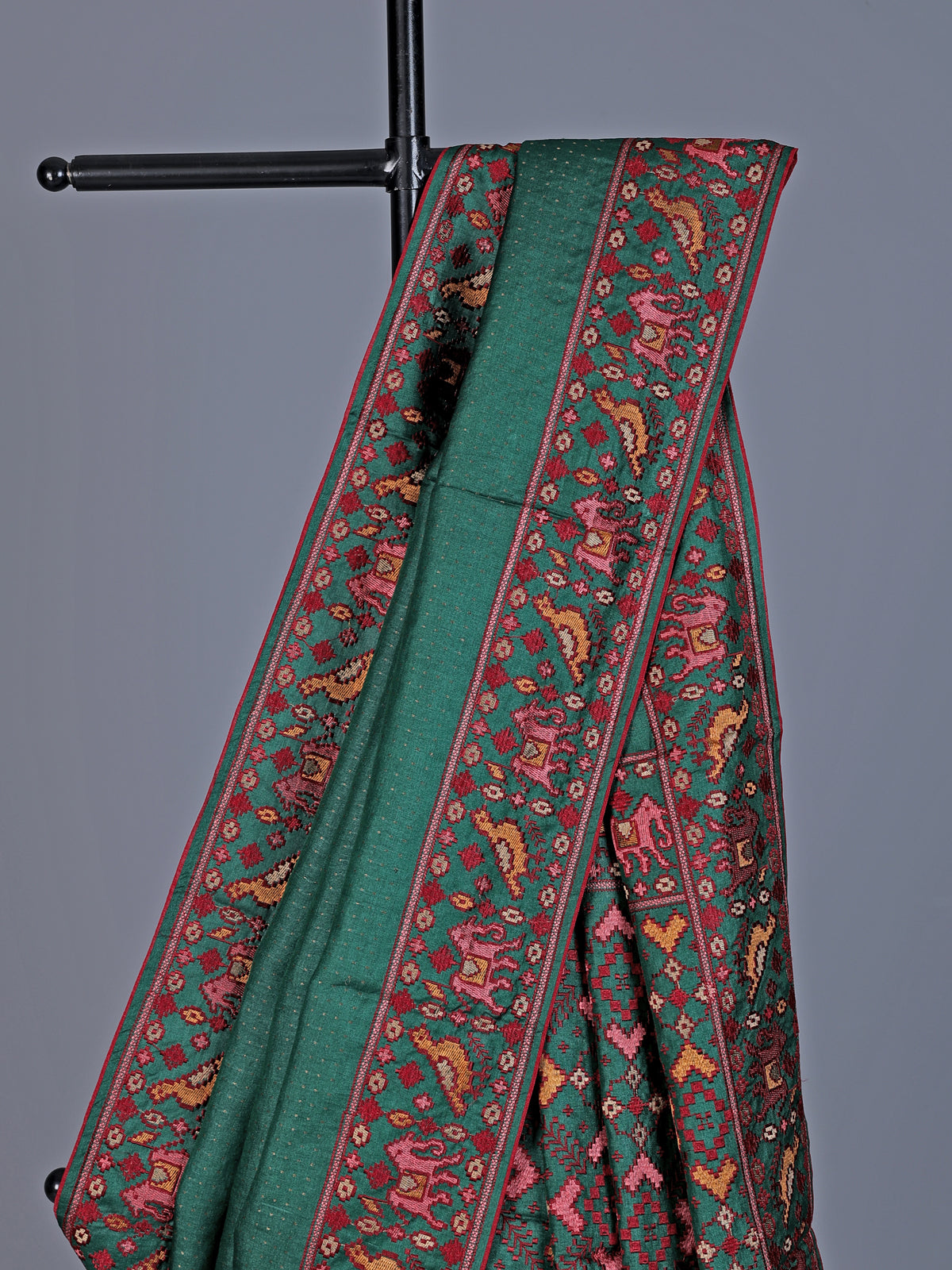 Deep green tusser silk saree with intricate animal motif artistry