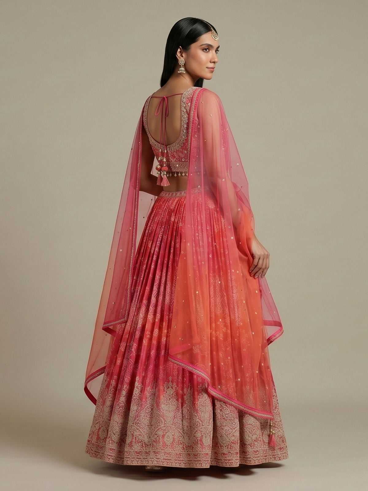 Pink silk bandhej lehenga choli with mirror and tassel work