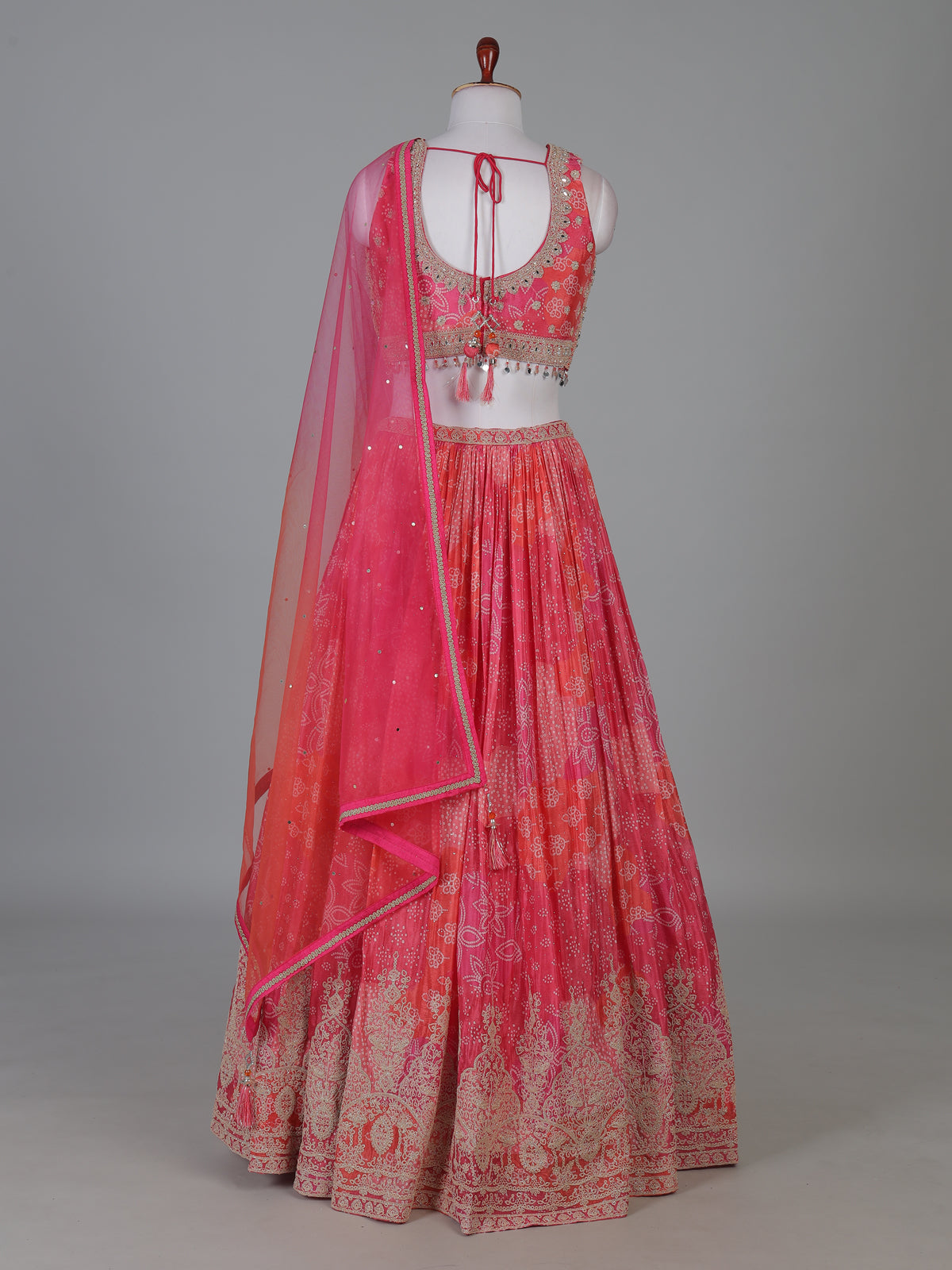 Pink silk bandhej lehenga choli with mirror and tassel work