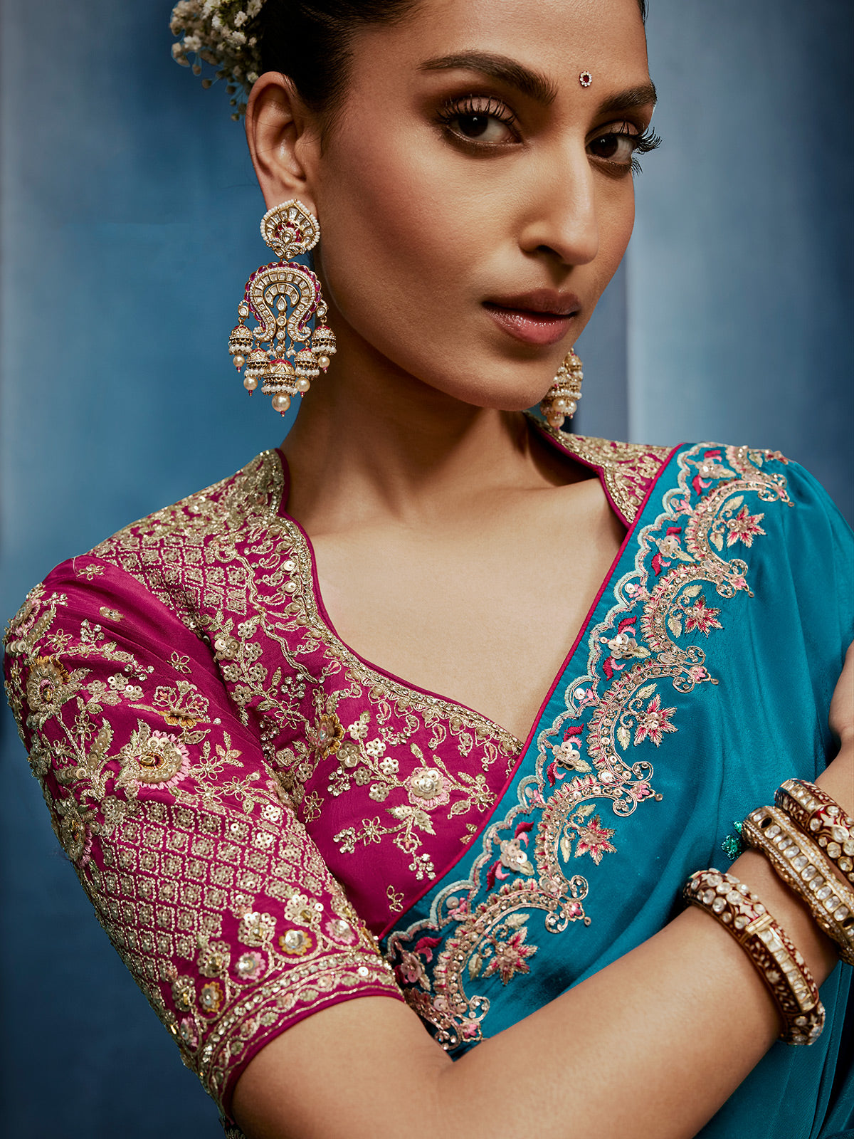 Blue silk saree paired with a striking red blouse