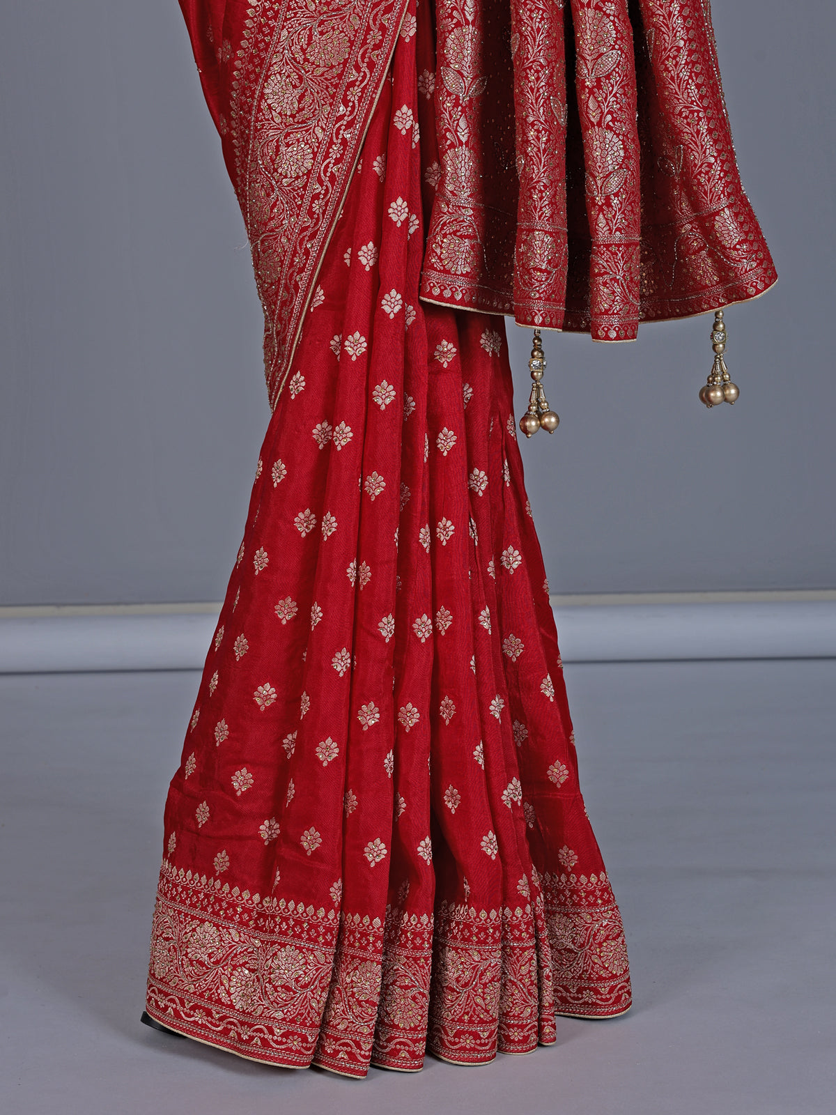 Red dola silk saree with stone zari butti work