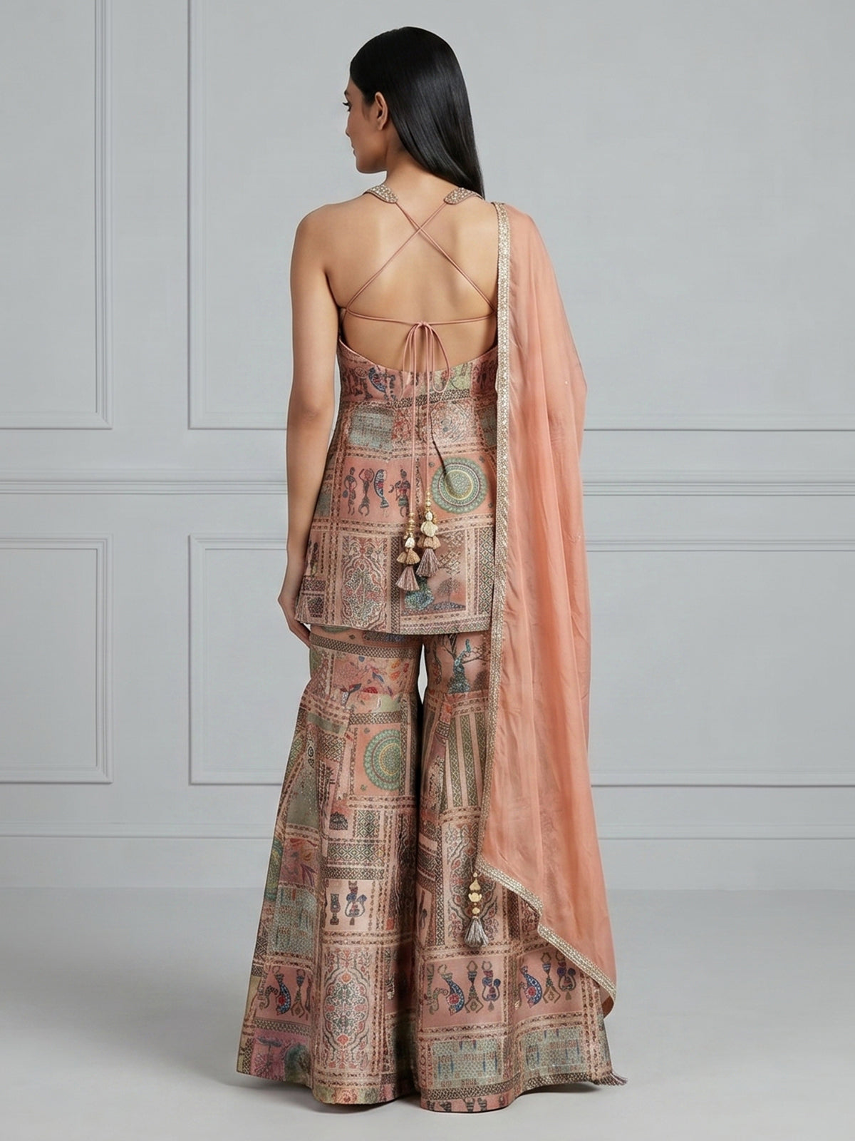 Pastel peach silk sharara suit with rich embellishment