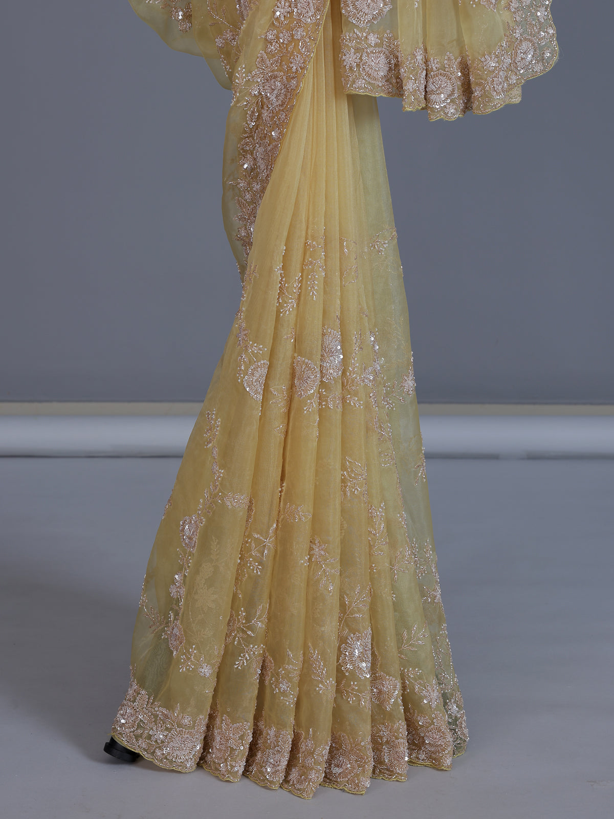 Yellow tissue silk saree with sequins and cutdana work