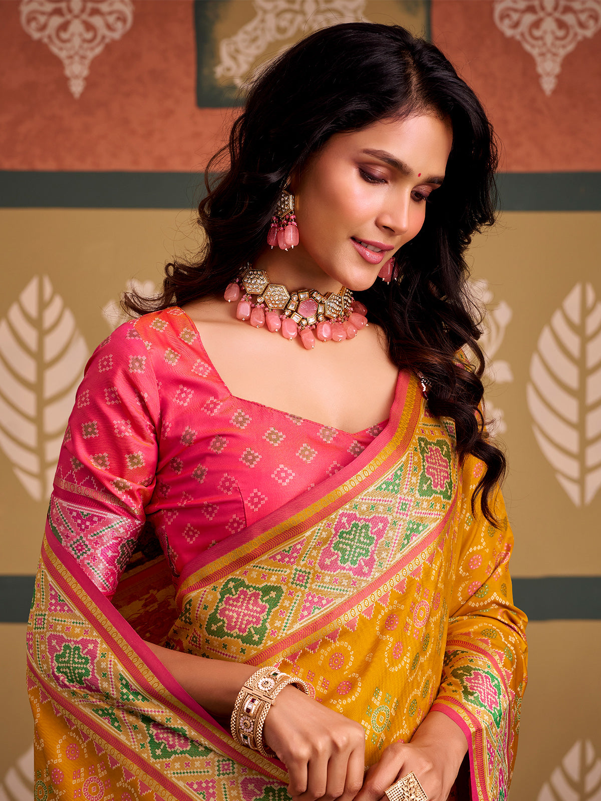 Radiant mustard yellow patola silk saree with contrast light pink blouse