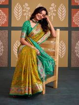 Majestic green bandhani patola silk saree with contrast sky blue blouse