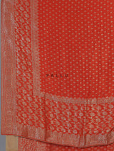 Rust orange premium dola silk saree with elegant zari artistry