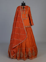 Rust orange raw silk lehenga choli with festive dupatta style