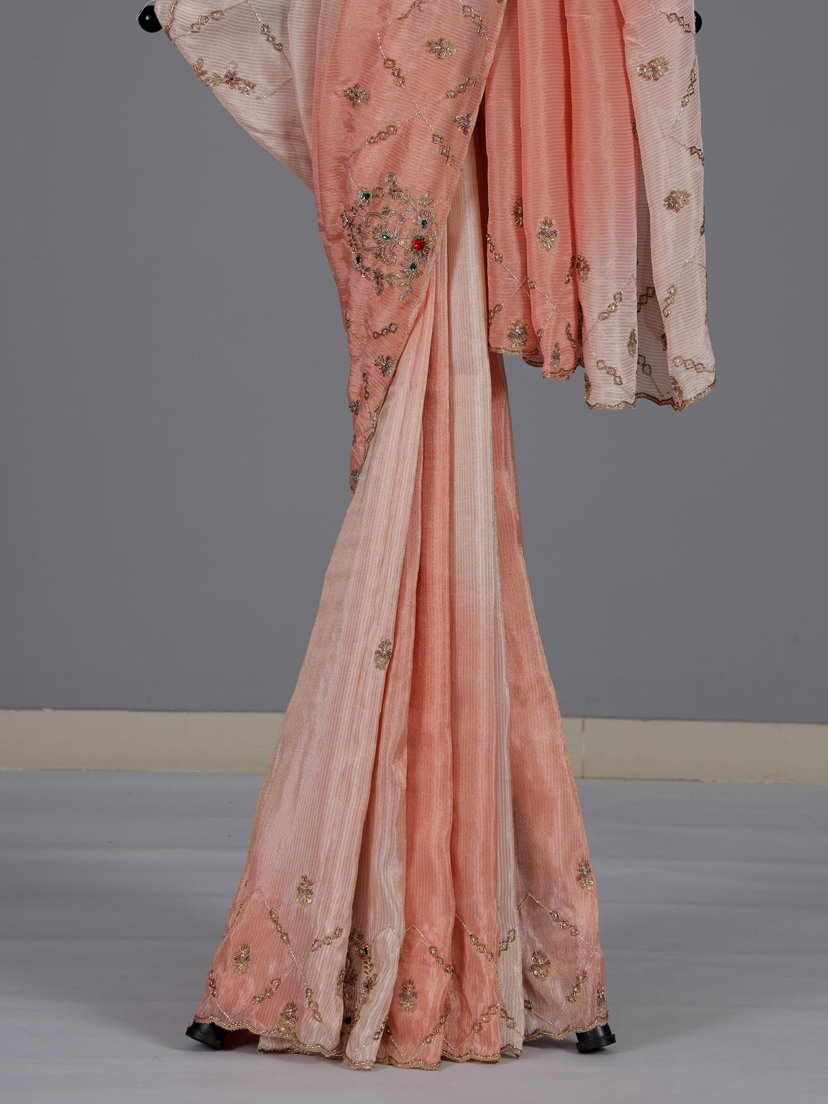 Graceful peach shaded dola shimmer saree for festive occasions