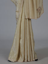 Cream shimmer dola silk festive saree with elegant handcrafted detailing