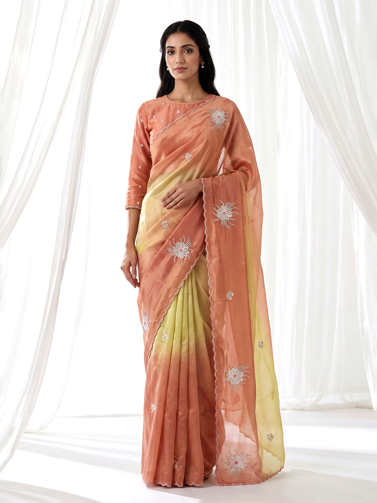 Peach shaded tissue silk designer saree with elegant festive shimmer