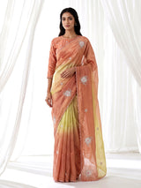 Peach shaded tissue silk designer saree with elegant festive shimmer