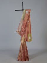 Peach shaded tissue silk designer saree with elegant festive shimmer