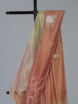 Peach shaded tissue silk designer saree with elegant festive shimmer
