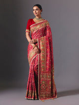 Rani pink art silk patola saree with festive handcrafted embellishments