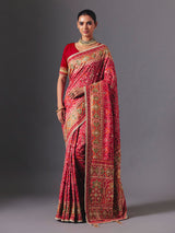 Rani pink art silk patola saree with festive handcrafted embellishments