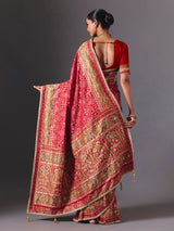 Rani pink art silk patola saree with festive handcrafted embellishments