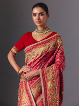 Rani pink art silk patola saree with festive handcrafted embellishments
