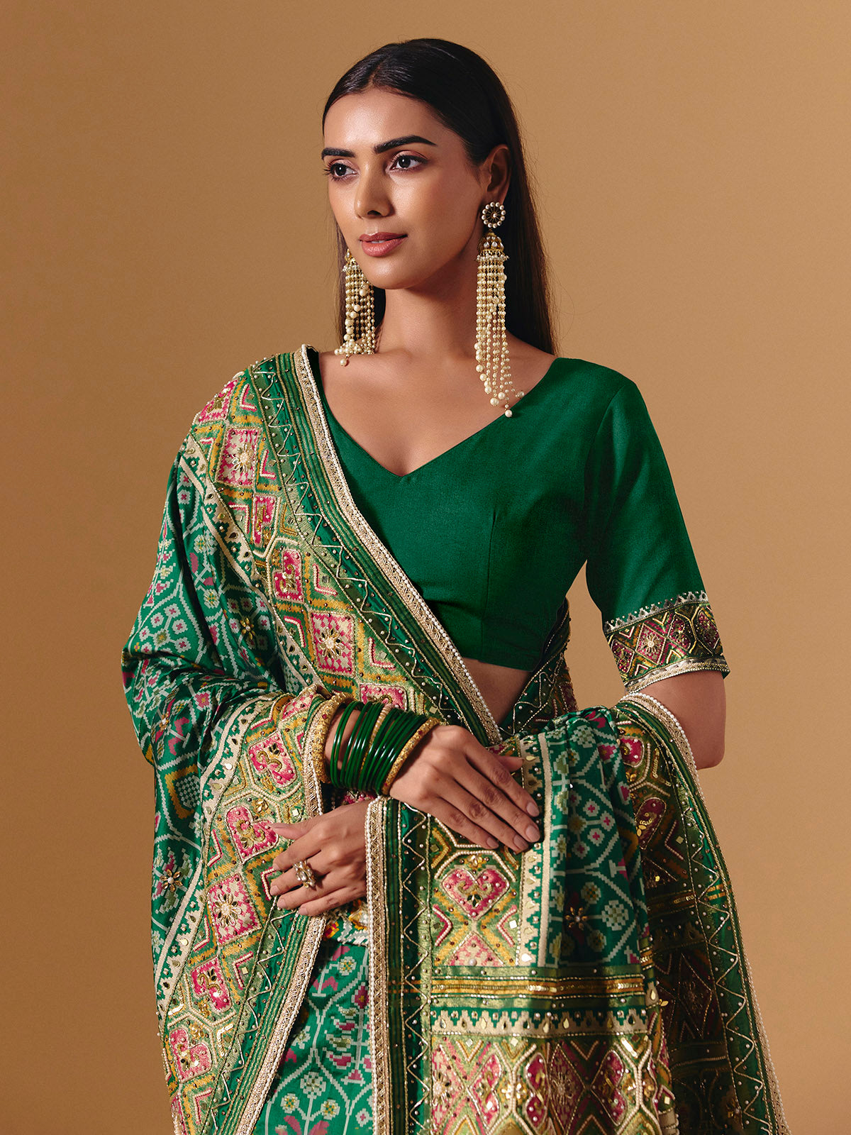 Green art silk patola print saree with timeless festive elegance