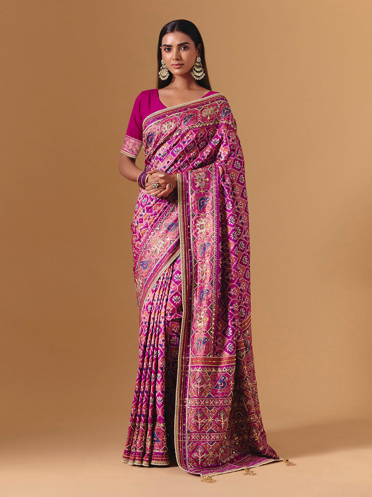 Rani pink art silk saree with graceful patola motif detailing
