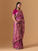 Rani pink art silk saree with graceful patola motif detailing
