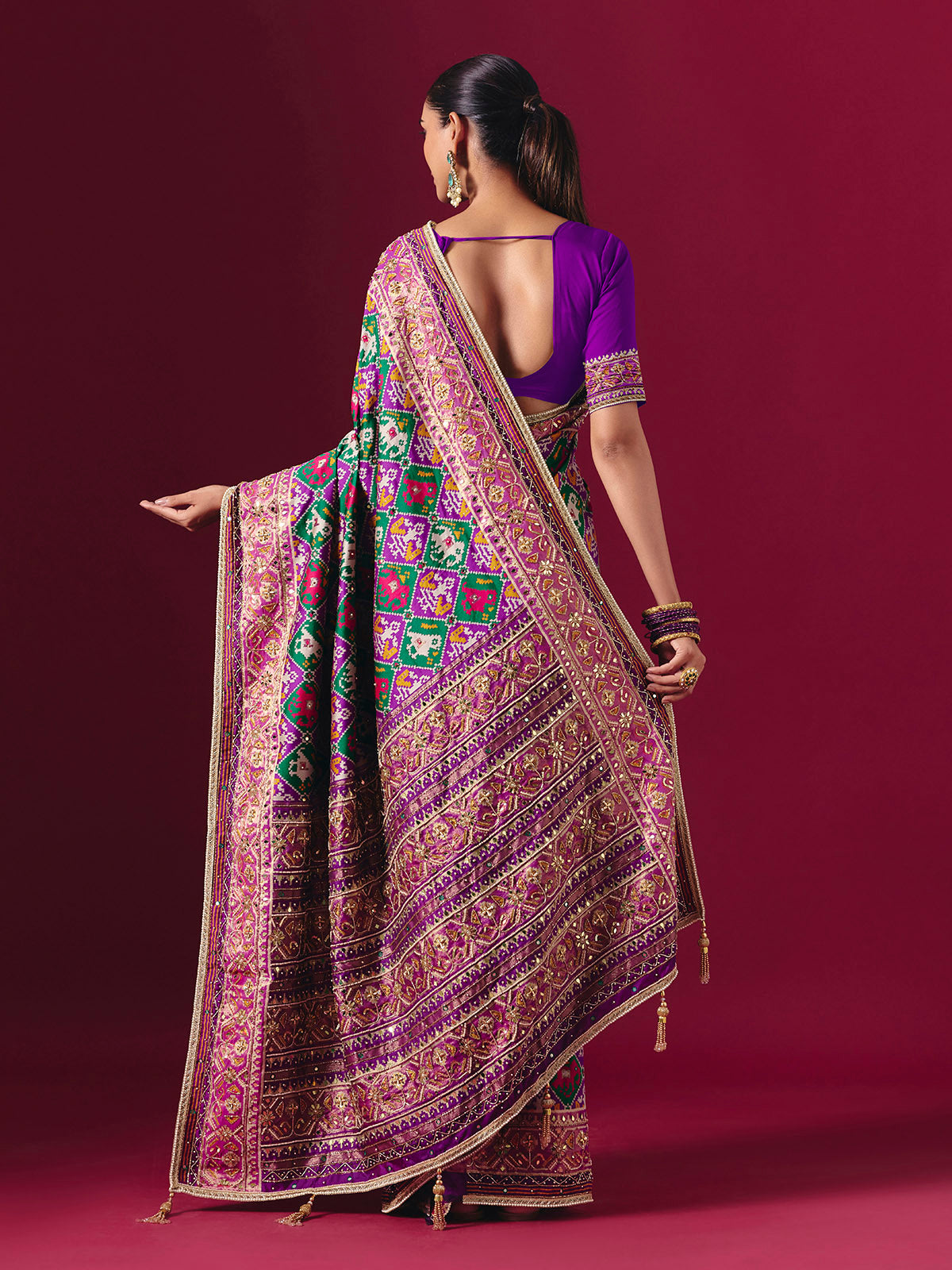 Purple and green art patola silk saree with festive motifs