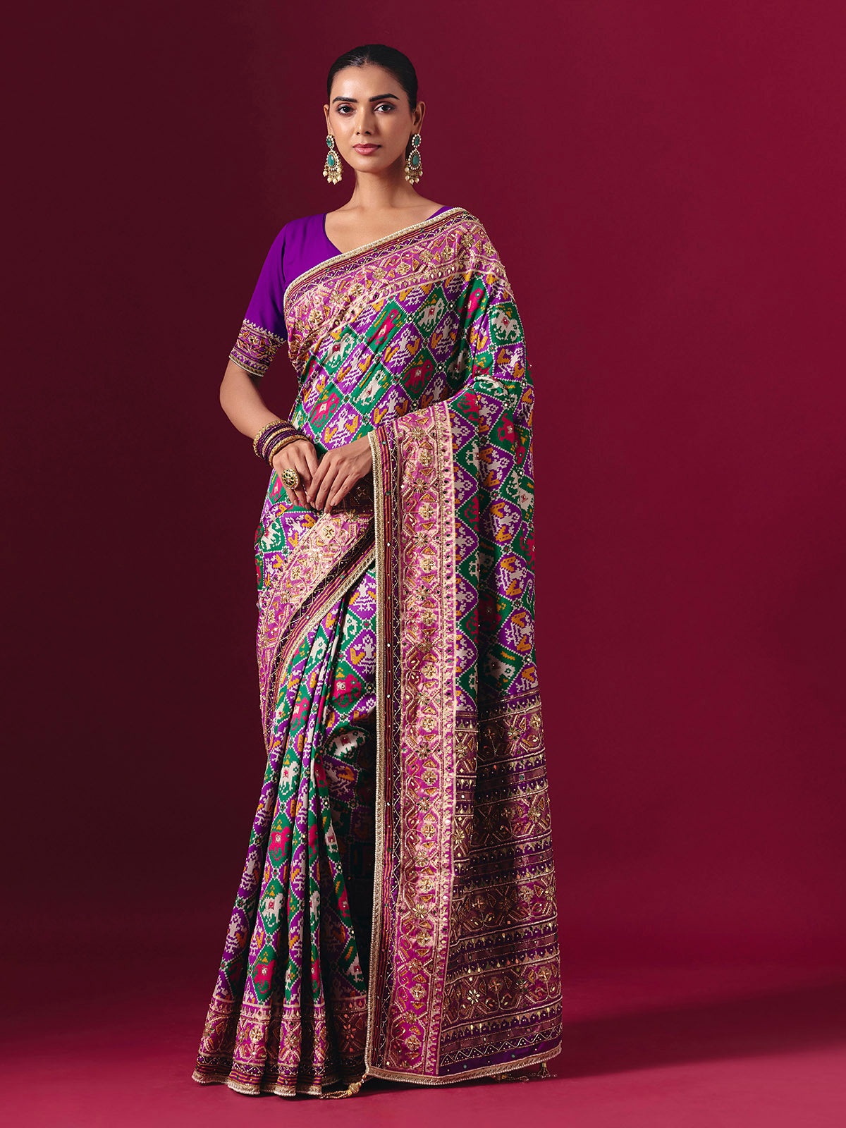 Purple and green art patola silk saree with festive motifs