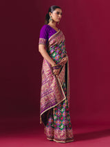 Purple and green art patola silk saree with festive motifs