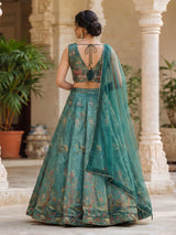 Teal green pichwai printed crepe silk lehenga choli ensemble