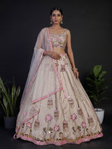 Beige silk lehenga choli with zardosi and mirror embellishments