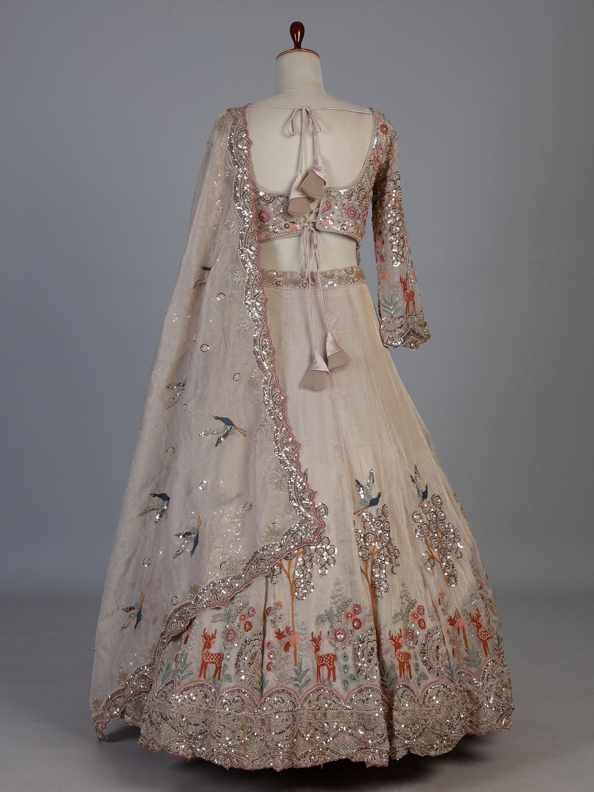 Beige silk designer lehenga choli with bird motif