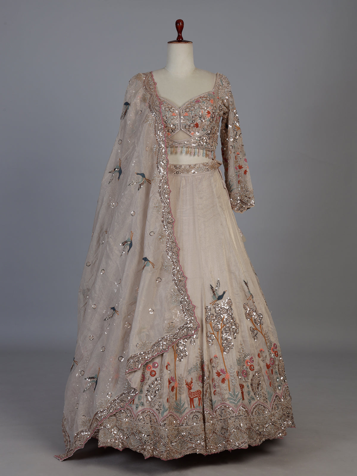 Beige silk designer lehenga choli with bird motif