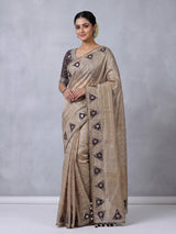 Pastel beige tusser silk saree with traditional handcrafted embellishments