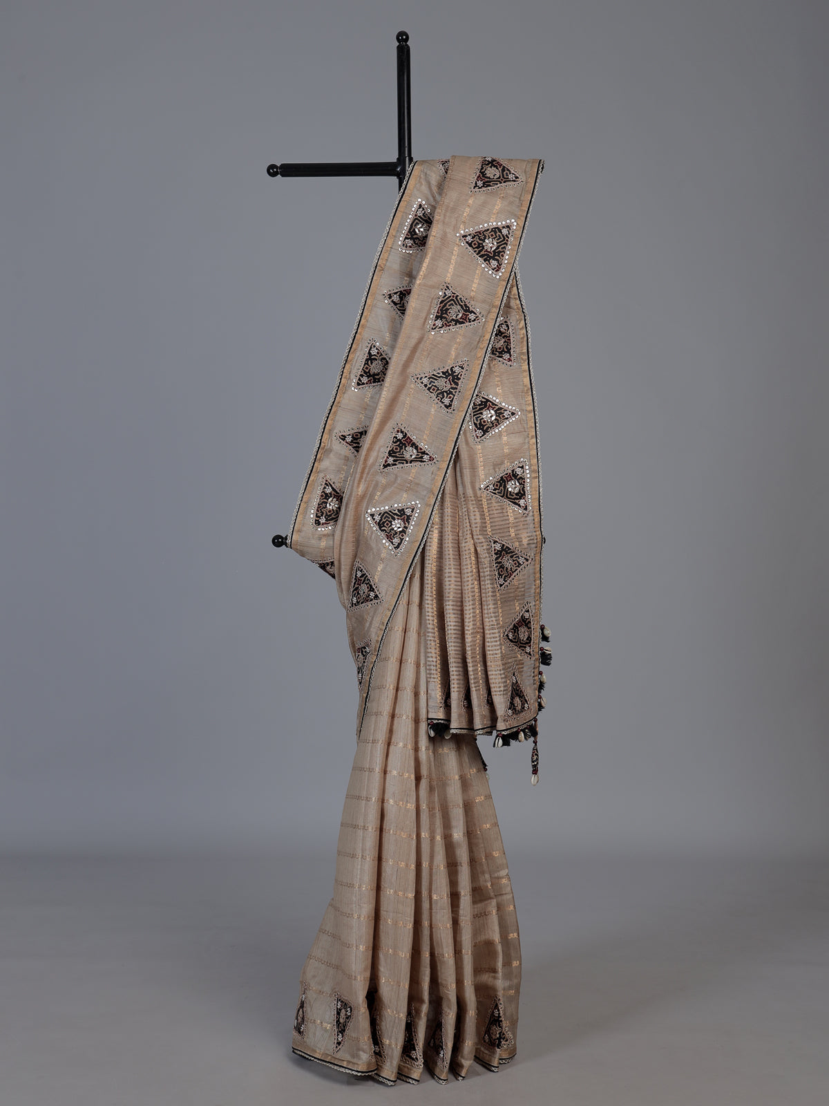 Pastel beige tusser silk saree with traditional handcrafted embellishments