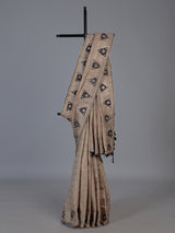 Pastel beige tusser silk saree with traditional handcrafted embellishments