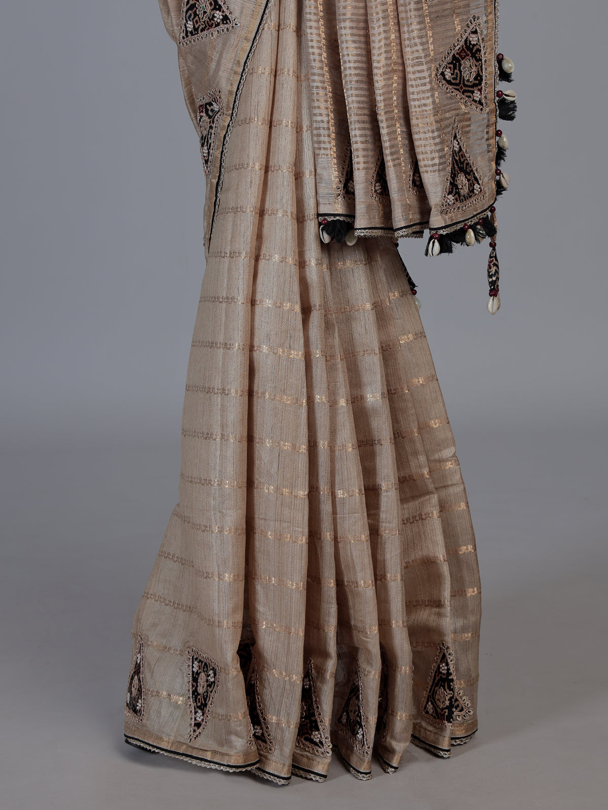 Pastel beige tusser silk saree with traditional handcrafted embellishments