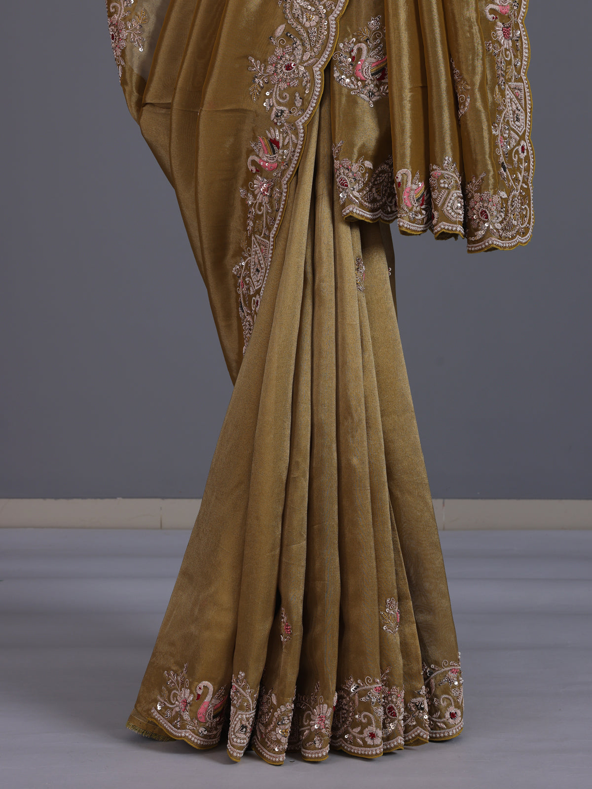 Gold tissue silk saree with bird motif border embellishments