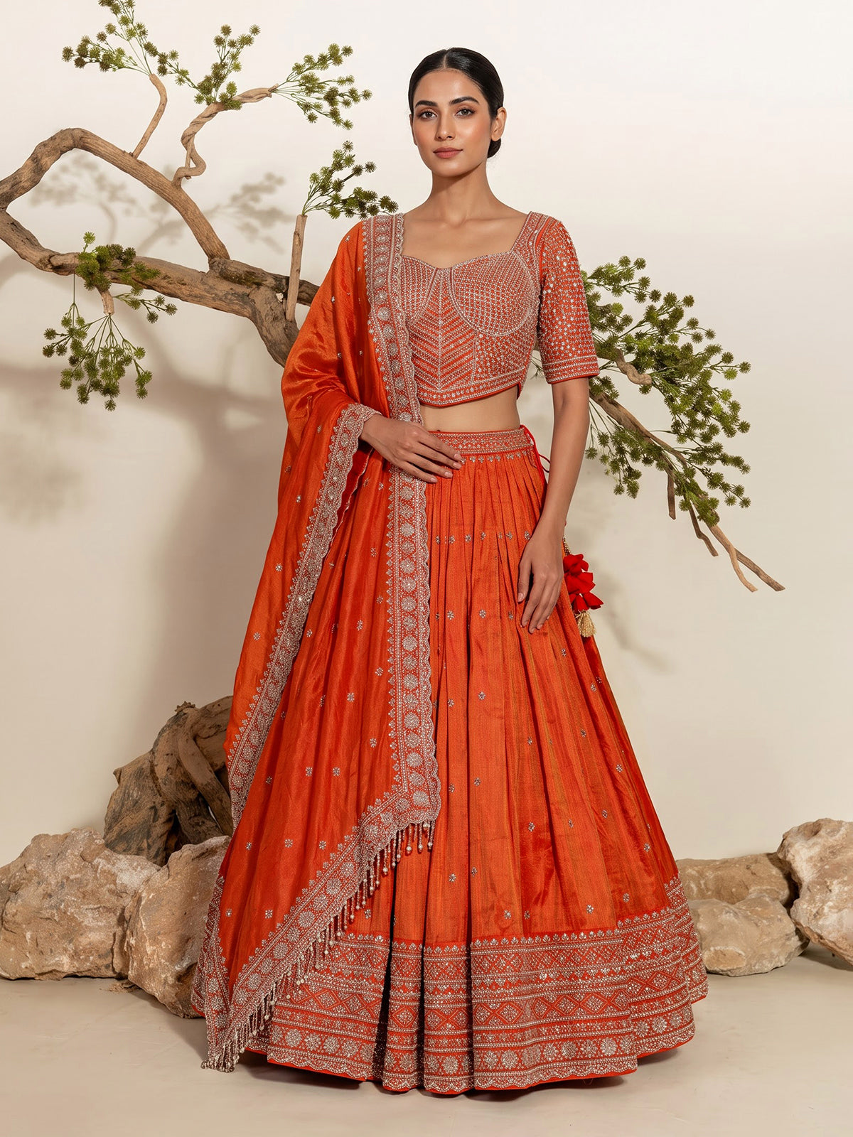 Rust orange silk embellished designer lehenga choli with tassel dupatta