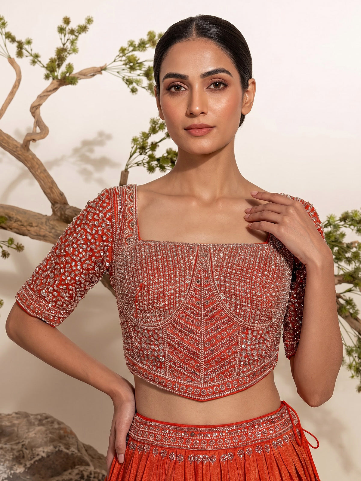Rust orange silk embellished designer lehenga choli with tassel dupatta