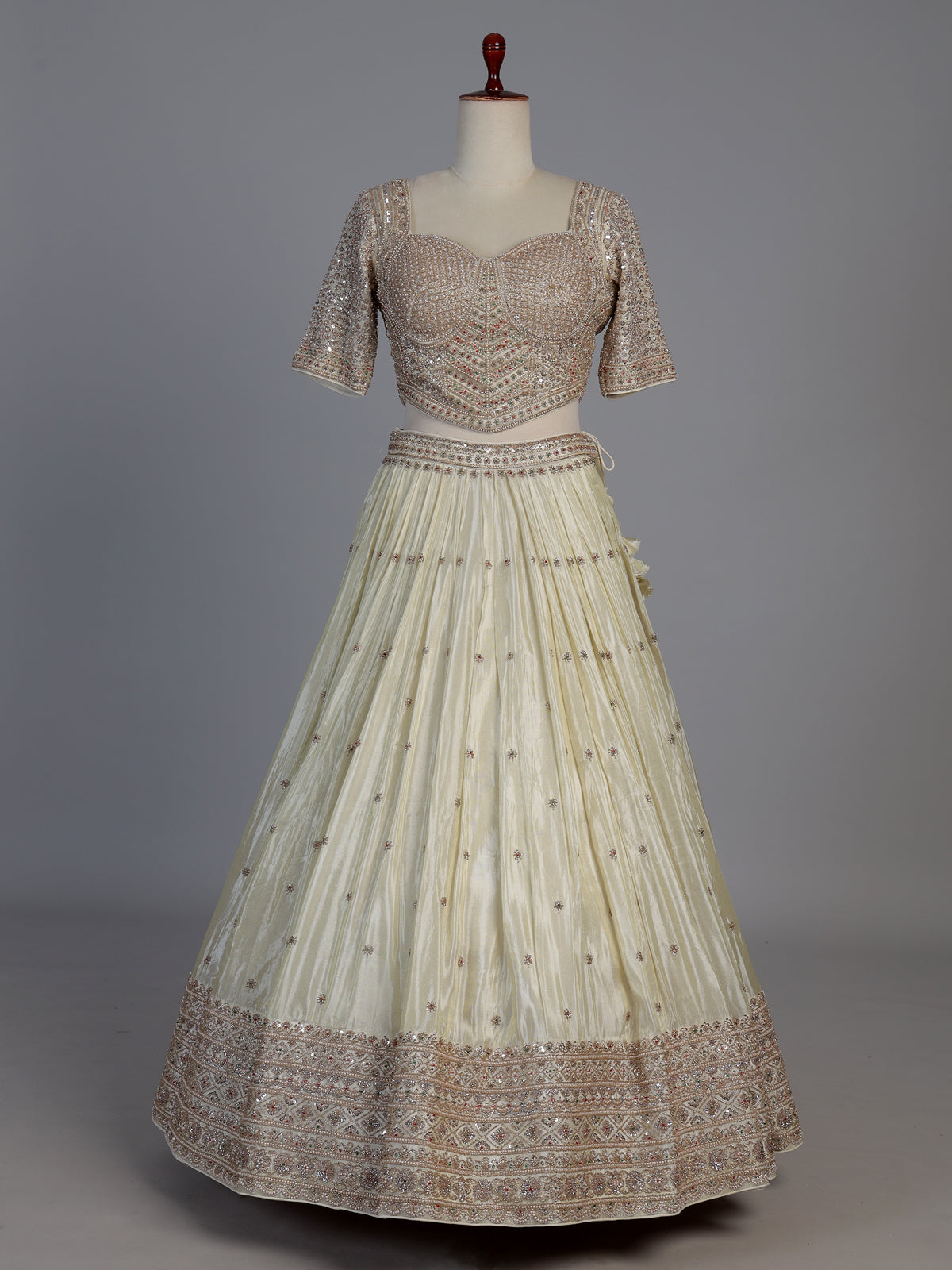 Cream silk designer embellished lehenga choli with tassel dupatta