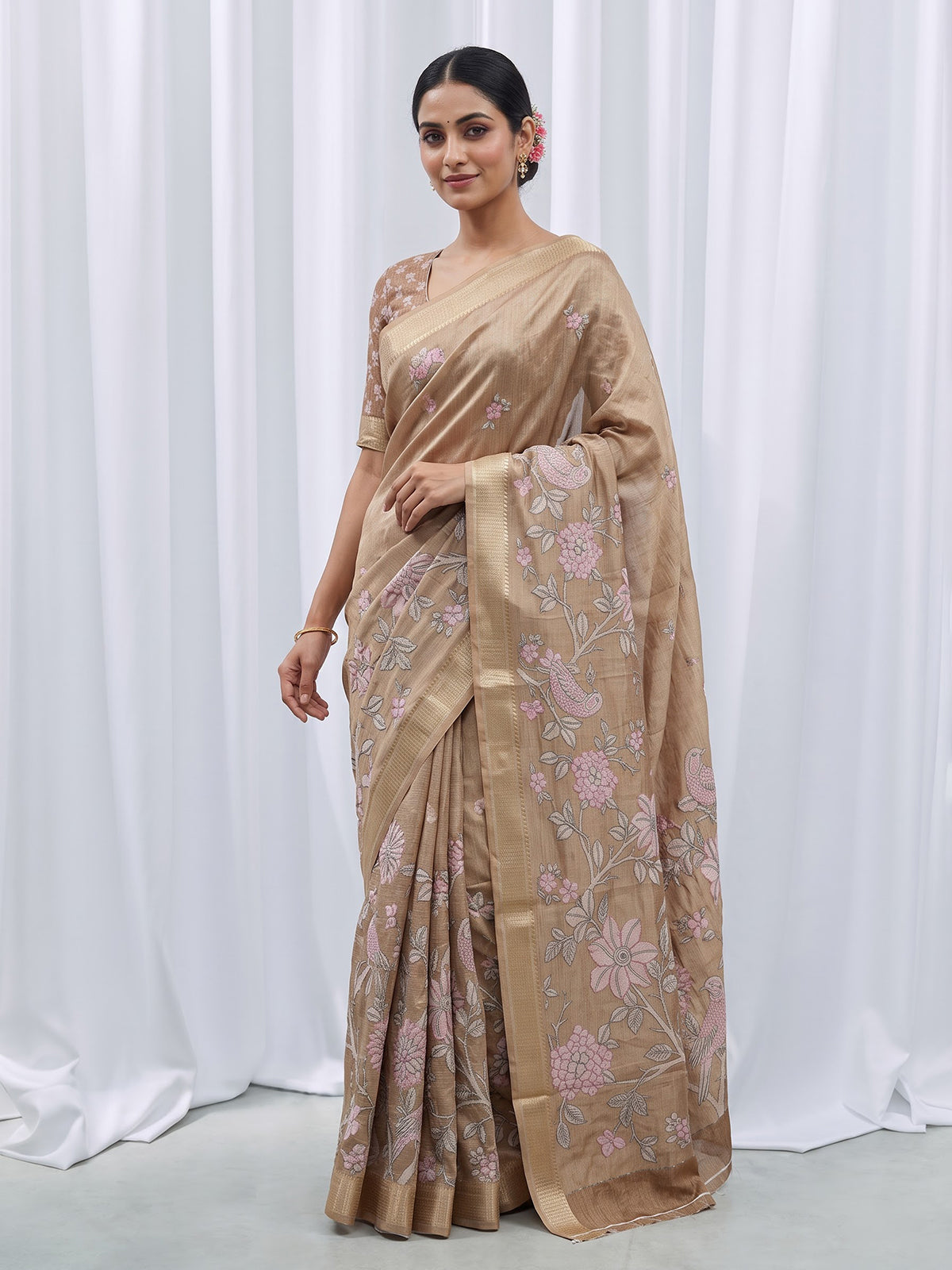 Pastel beige cotton silk saree with elegant bird motifs
