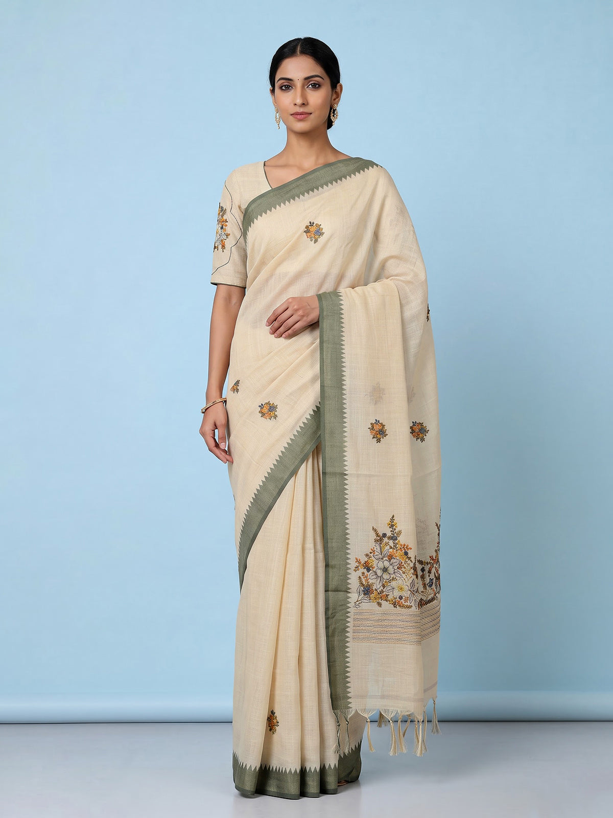 Cream cotton saree with floral threadwork and contrast border