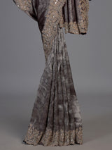 Pastel grey tissue silk saree with delicate pearl zari embellishments