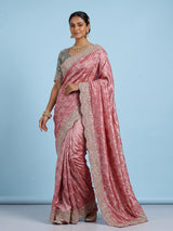 Pastel rani pink tissue silk saree with luxurious zari detailing