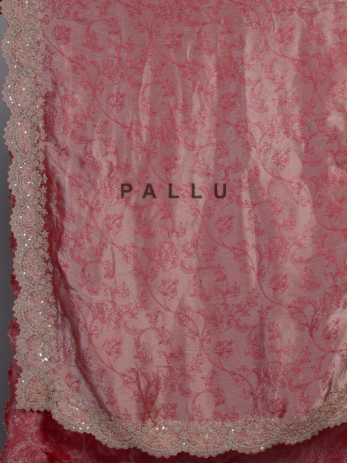 Pastel rani pink tissue silk saree with luxurious zari detailing