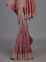 Pastel rani pink tissue silk saree with luxurious zari detailing