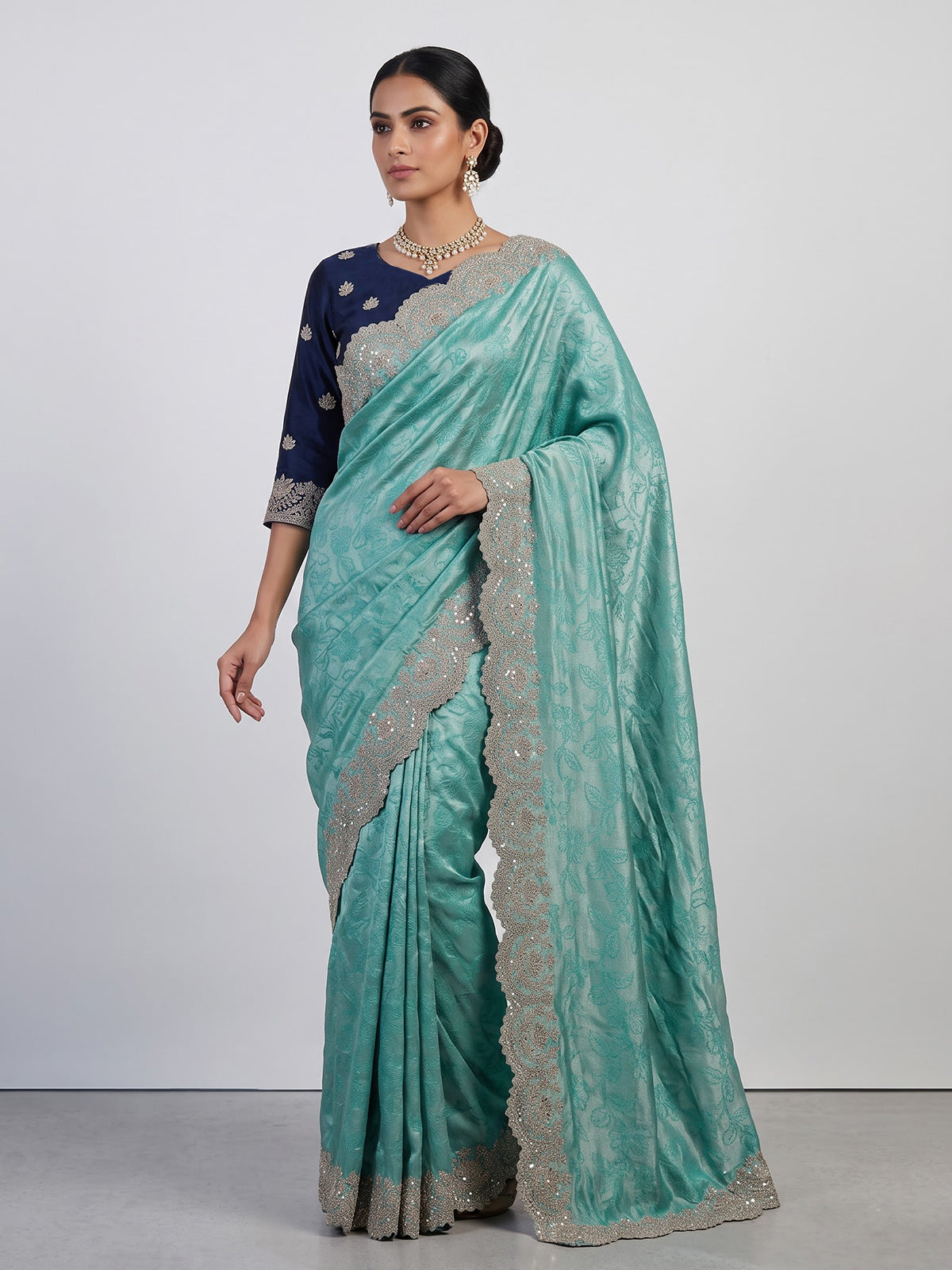 Pastel rama green tissue silk saree with elegant embellishments