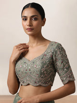 Sage green silk lehenga choli with exquisite animal artistry