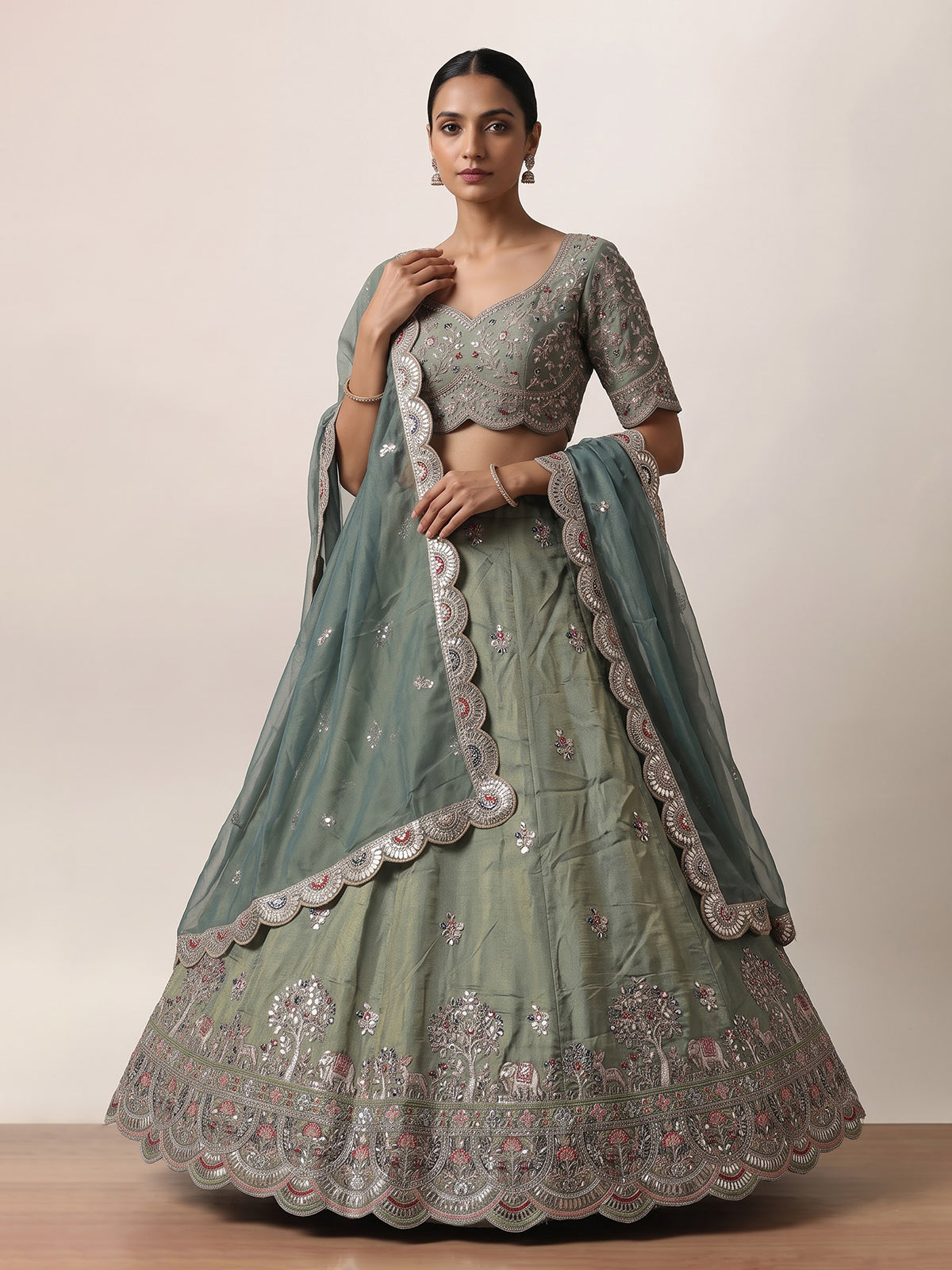 Sage green silk lehenga choli with exquisite animal artistry