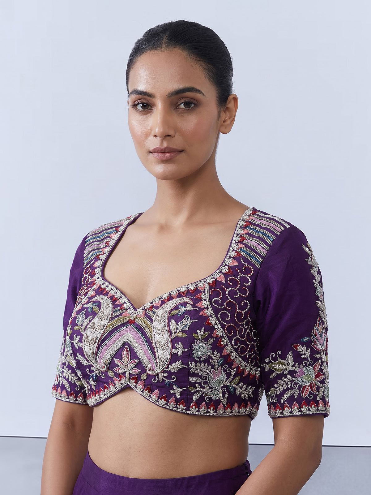 Royal purple silk lehenga choli with intricate festive craftsmanship