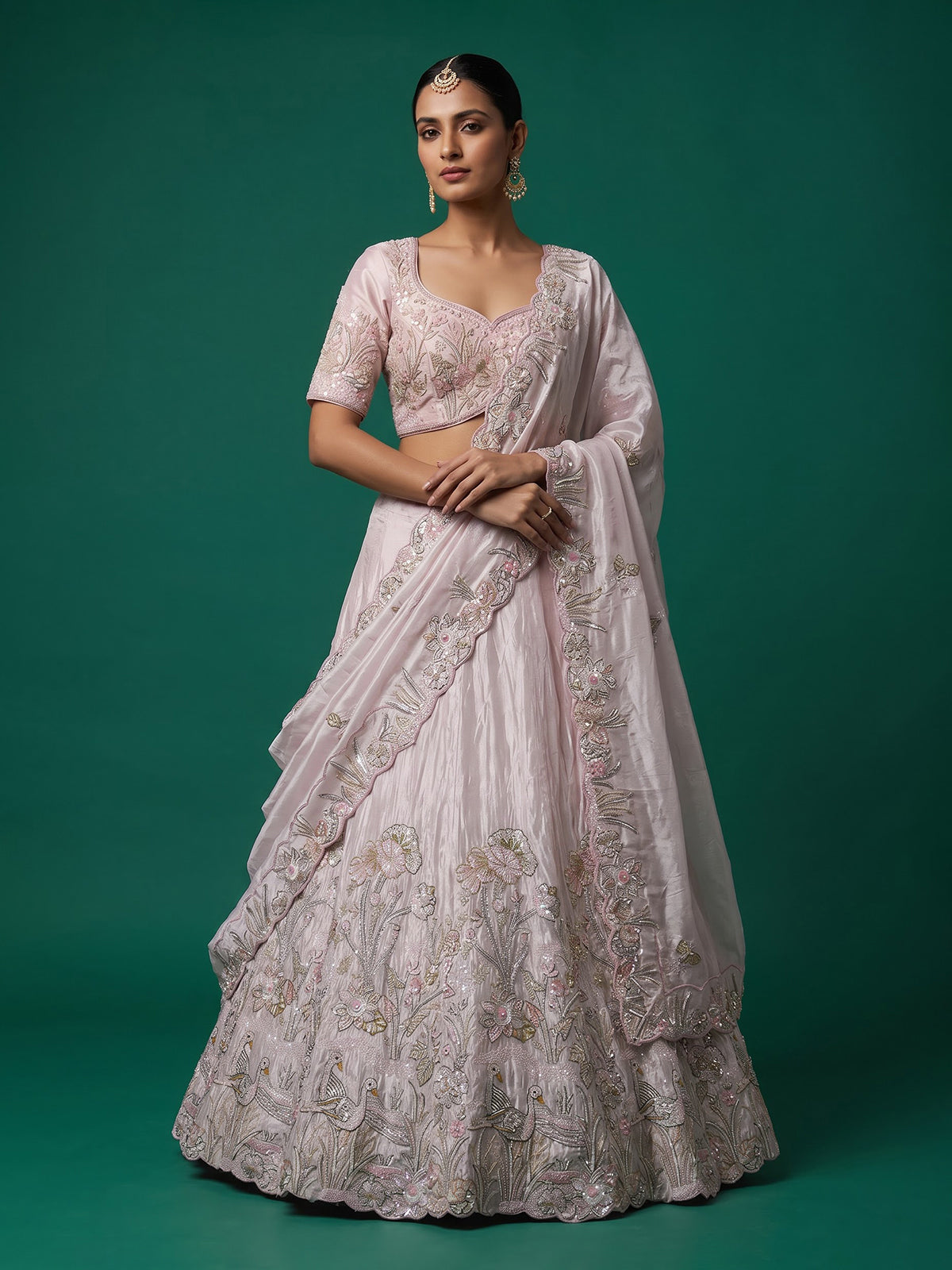 Pink tissue silk lehenga choli adorned with floral bird artistry